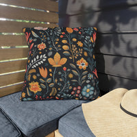 Thumbnail for Floral patterned pillow on a cushioned chair outdoors with a straw hat nearby.