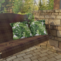 Thumbnail for Wooden swing with green leaf-patterned cushions in an outdoor setting.