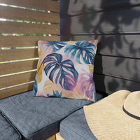 Thumbnail for Outdoor seating area with a colorful leaf-patterned pillow and a straw hat.