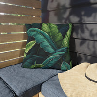 Thumbnail for Outdoor seating with a tropical leaf pattern pillow and a straw hat.