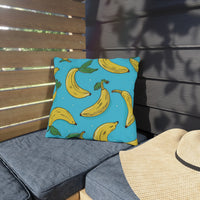 Thumbnail for Pillow with banana pattern on a gray cushion outdoors
